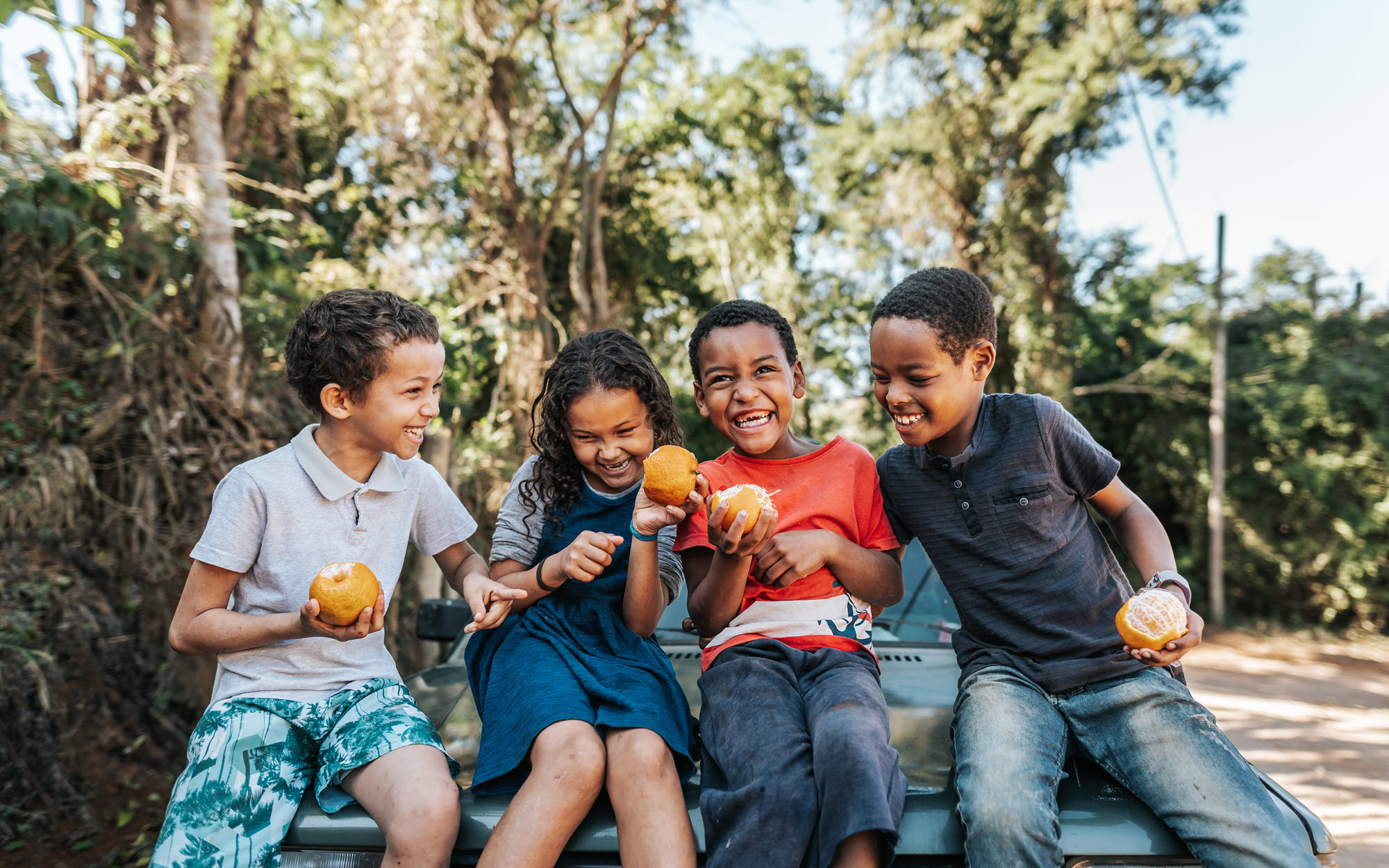 Photo of children eating fruit and laughing