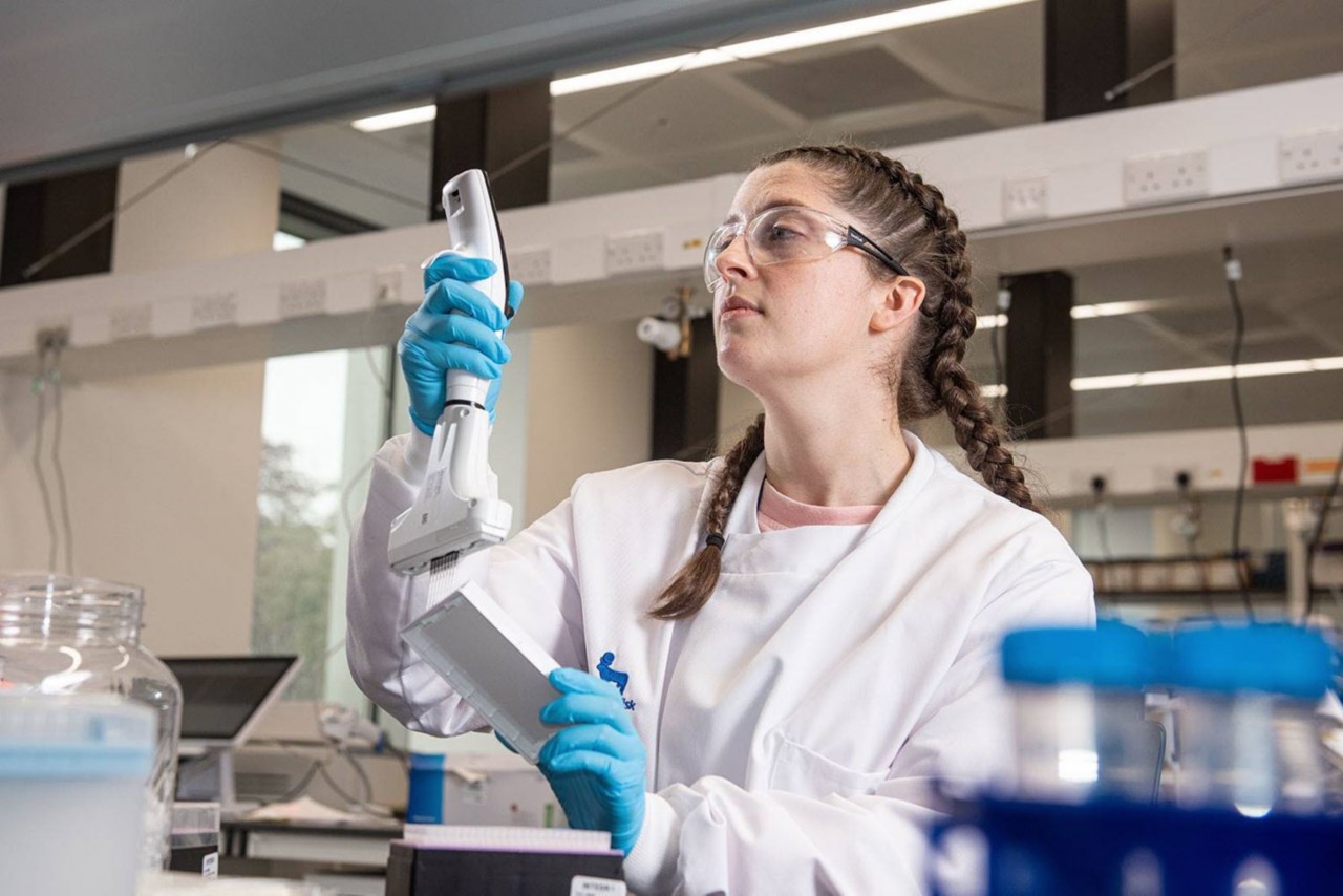 Novo Nordisk colleague looking at test tube in the lab