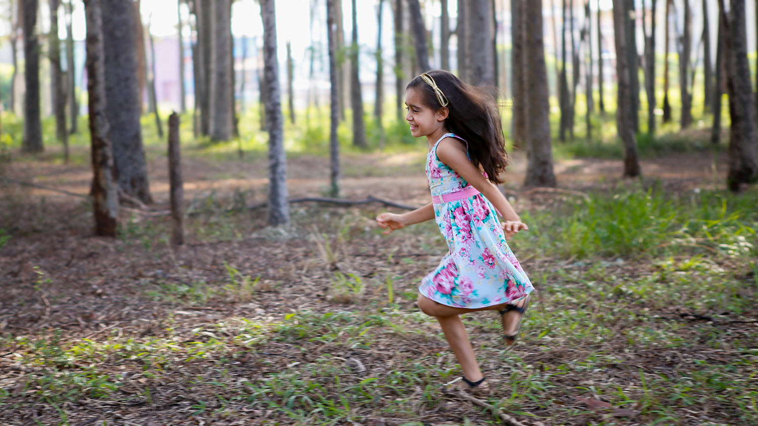 Image of a young girl running in the forest