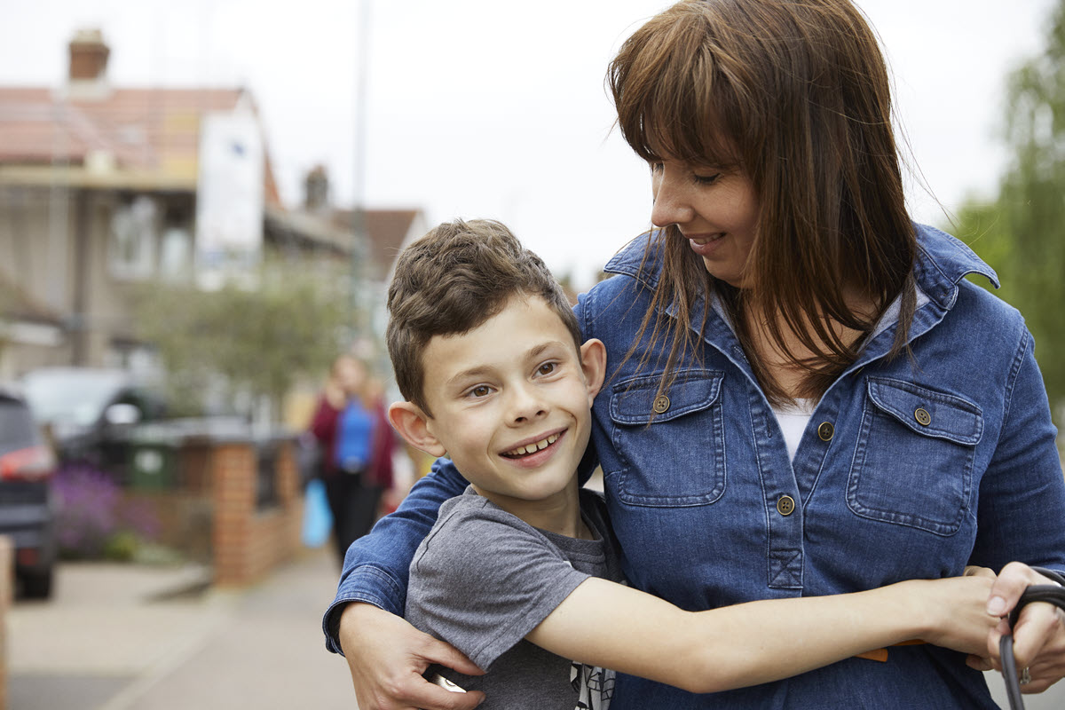 Photo of Jake Lowe and his mother in the UK. Jake is living with a growth hormone disorder.