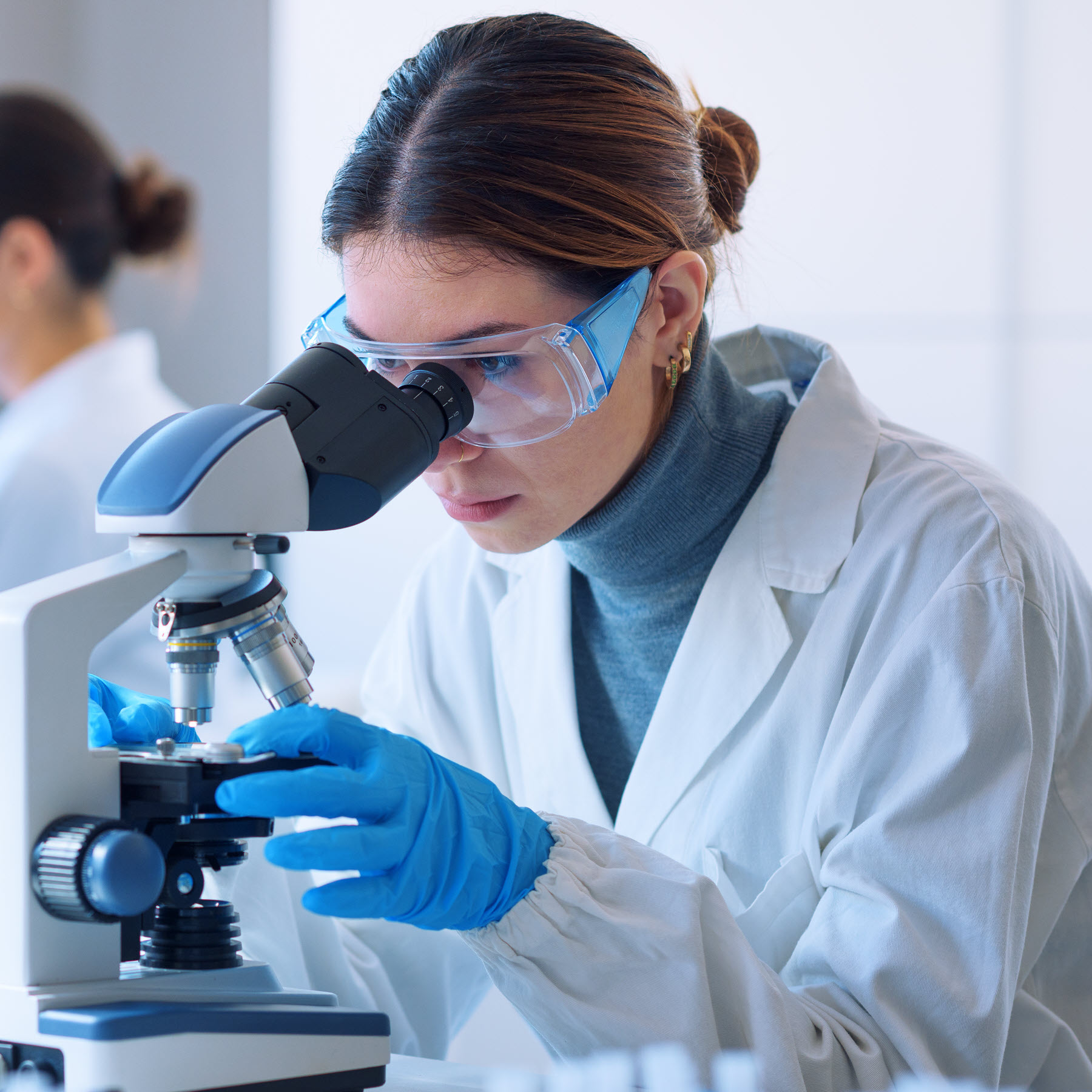 Image of a scientist looking into a microscope